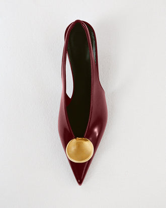 Proenza Schouler Editorial Still Life Image of Dome Slash Slingbacks in Polished Calf in Merlot 