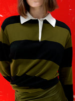 Proenza Schouler Cropped Campaign image of model wearing Corinna Top in Cotton Stripe in Black Multi with the Naia Skirt in Viscose Satin Jersey in Moss