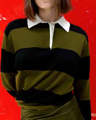 Proenza Schouler Cropped Campaign image of model wearing Corinna Top in Cotton Stripe in Black Multi with the Naia Skirt in Viscose Satin Jersey in Moss