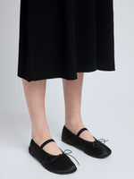 Image of model wearing Glove Mary Jane Ballet Flats in Satin in BLACK