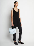 Image of model carrying Small Ruched Crossbody Tote in PALE BLUE by hand