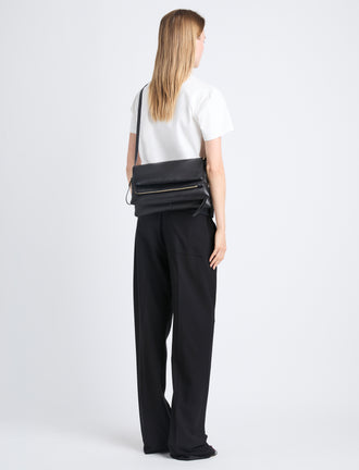 Image of model carrying City Bag in Black from the back