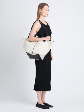 Image of model wearing XL Chelsea Tote in Canvas in black/natural 