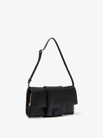 Side image of Flip Shoulder Bag in Black with strap