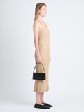 Image of model holding Flip Shoulder Bag in Black with strap up