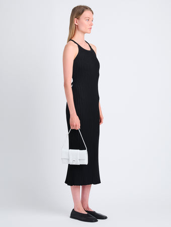 Image of model carrying Flip Shoulder Bag in Optic White with strap up