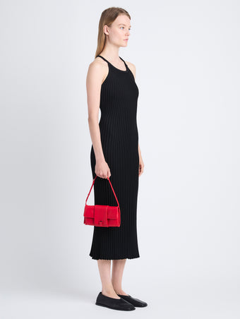 Image of model holding Flip Shoulder Bag in Red with strap up