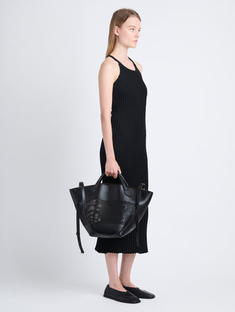 Image of model wearing Large Chelsea Tote in Perforated Leather in black