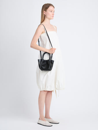 Image of model wearing Extra Small Ruched Tote in Perforated Leather in black