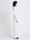 Image of model carrying Park Shoulder Bag in Optic White Nylon with Feathers on shoulder