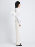 Image of model carrying Park Shoulder Bag in Optic White Nylon with Feathers on shoulder