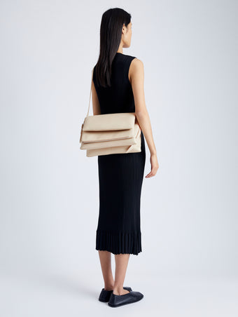 Image of model wearing City Messenger Bag in TAUPE