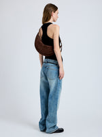 Image of model wearing Slide Bag in Soft Suede in Chocolate