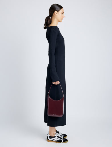Image of model wearing Slope Shoulder Bag In Soft Spazzolato in DARK RED