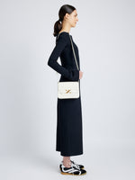 Side image of model wearing Monogram Box Bag in CREAM