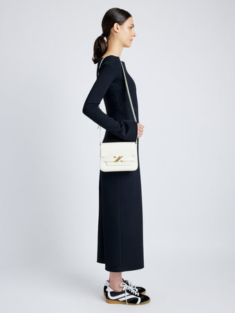 Side image of model wearing Monogram Box Bag in CREAM