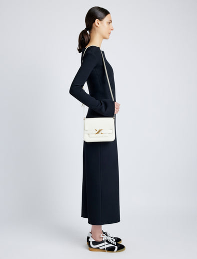 Side image of model wearing Monogram Box Bag in CREAM