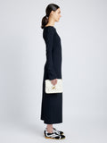 Side image of model carrying Monogram Box Bag in CREAM