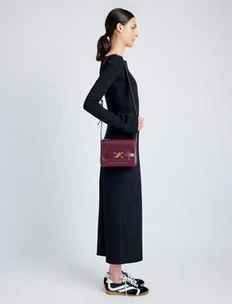 Side image of model wearing Monogram Box Bag in DARK RED