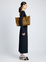 Proenza Schouler Front full length image of model carrying Tate Bag in Nubuck Calf in TOBACCO