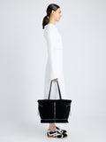 Proenza Schouler image of model carrying Days Tote in Shearling Backed Suede in black
