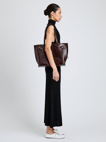 Proenza Schouler Image of model wearing Days Tote in Pull Up Calf Skin in Dark Brown