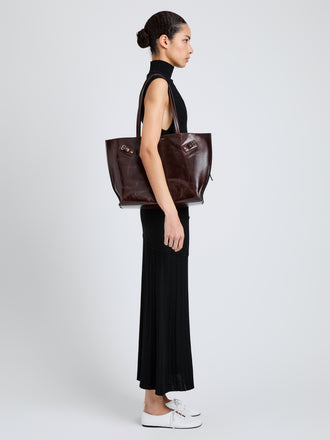 Proenza Schouler Image of model wearing Days Tote in Pull Up Calf Skin in Dark Brown