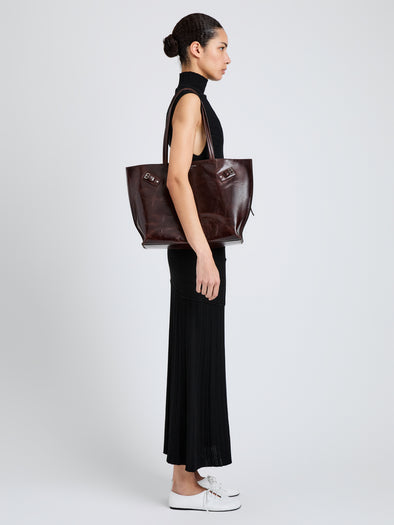 Proenza Schouler Image of model wearing Days Tote in Pull Up Calf Skin in Dark Brown