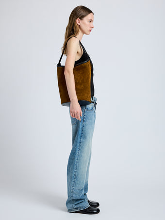 Image of model wearing Brant Bucket Bag in Soft Suede in Fern