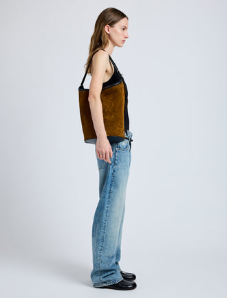 Image of model wearing Brant Bucket Bag in Soft Suede in Fern