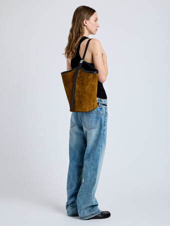 Image of model wearing Brant Bucket Bag in Soft Suede in Fern