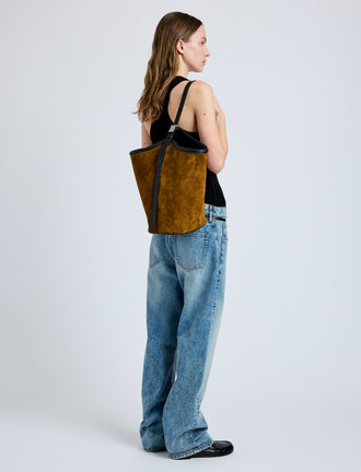 Image of model wearing Brant Bucket Bag in Soft Suede in Fern