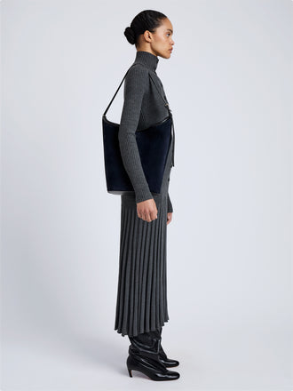 Proenza Schouler Image of model wearing Brant Bucket Bag in Soft Suede in Dark Navy