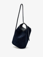 Proenza Schouler Front image of Brant Bucket Bag in Soft Suede in Dark Navy held crossbody