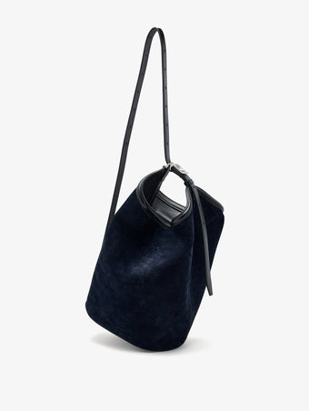 Proenza Schouler Front image of Brant Bucket Bag in Soft Suede in Dark Navy held crossbody