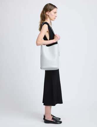 Image of model wearing Brant Bucket Bag in Smooth Calf in Smoke