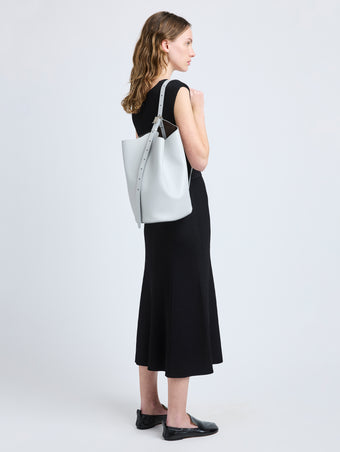 Image of model wearing Brant Bucket Bag in Smooth Calf in Smoke