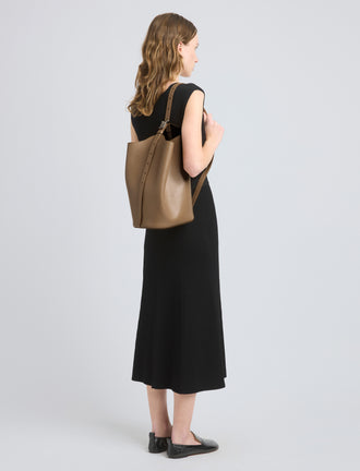 Image of model wearing Brant Bucket Bag in Smooth Calf in Cumin
