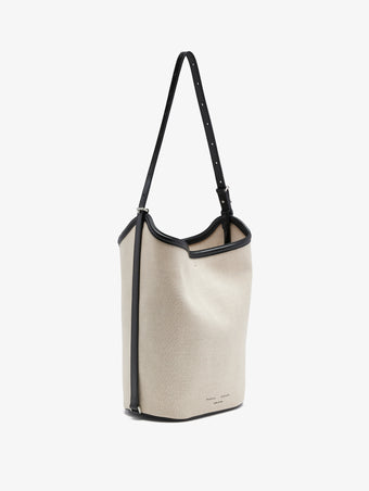 Proenza Schouler front 3/4 image of Brant Bucket Bag in Natural Linen in natural/black