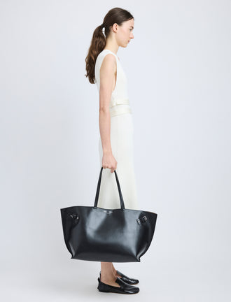 Proenza Schouler image of model carrying Days Carryall in Smooth Calf in black