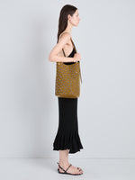 Proenza Schouler Image of model wearing Brant Bucket Bag in Eyelet Covered Suede in Hazelnut