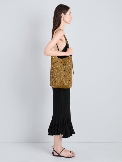 Proenza Schouler Image of model wearing Brant Bucket Bag in Eyelet Covered Suede in Hazelnut