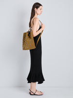 Proenza Schouler Image of model wearing Brant Bucket Bag in Eyelet Covered Suede in Hazelnut