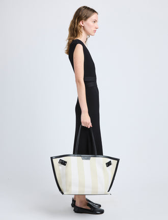 Proenza Schouler image of model carrying Days Carryall in Striped Canvas in resin/white