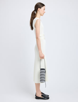 Proenza Schouler image of model carrying Silo Bag in Pieced Stripes in black/white