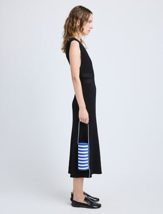 Proenza Schouler image of model carrying Silo Bag in Pieced Stripes in cobalt/white