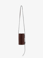 Proenza Schouler front image of Crossbody Silo Bag in Shiny Calf in cedar hanging vertically