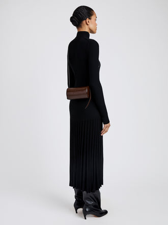 Proenza Schouler image of model wearing Crossbody Silo Bag in Shiny Calf in cedar