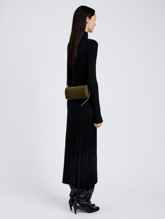 Proenza Schouler Image of model wearing Crossbody Silo Bag in Kid Suede in Olive