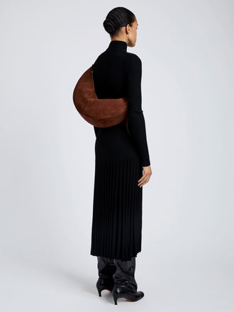 Proenza Schouler Image of model wearing Hobo Slide Bag in Soft Suede in Rust
